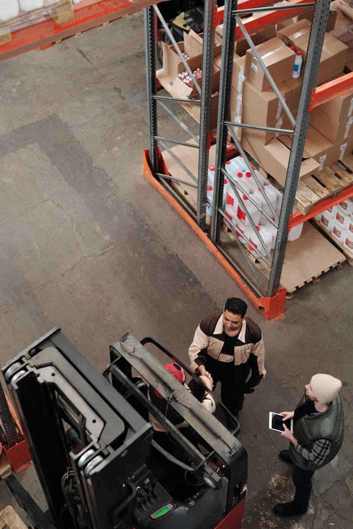about-02 High angle view of staff collaborating in a warehouse, showcasing teamwork and logistics.
